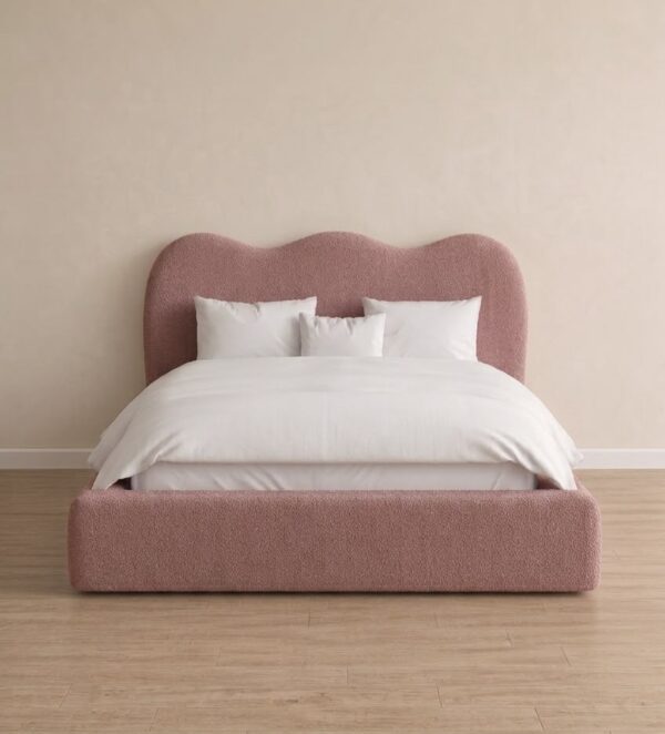 Light pink upholstered wave headboard and padded footboard.